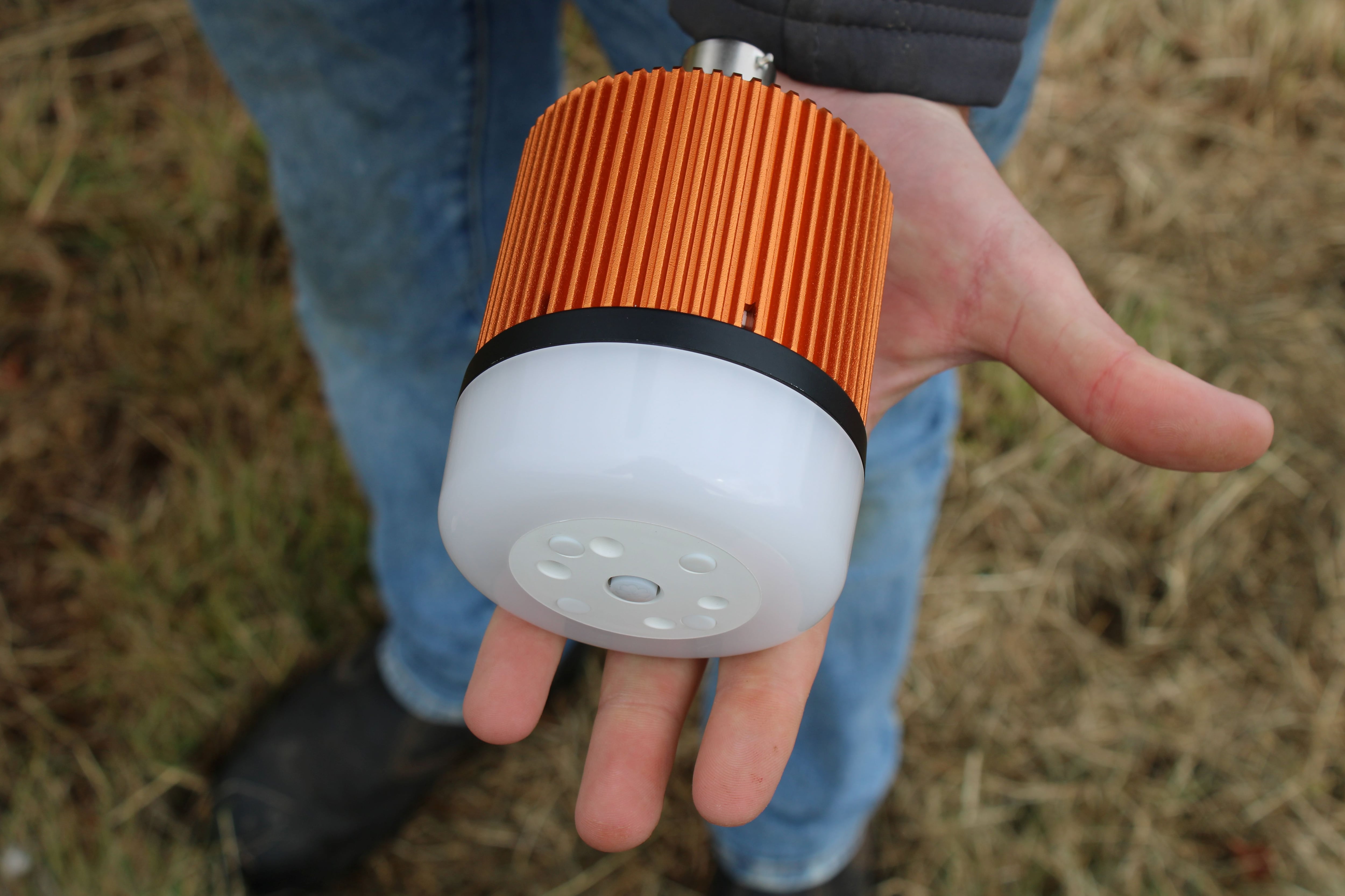 A hand holding an acoustic device.