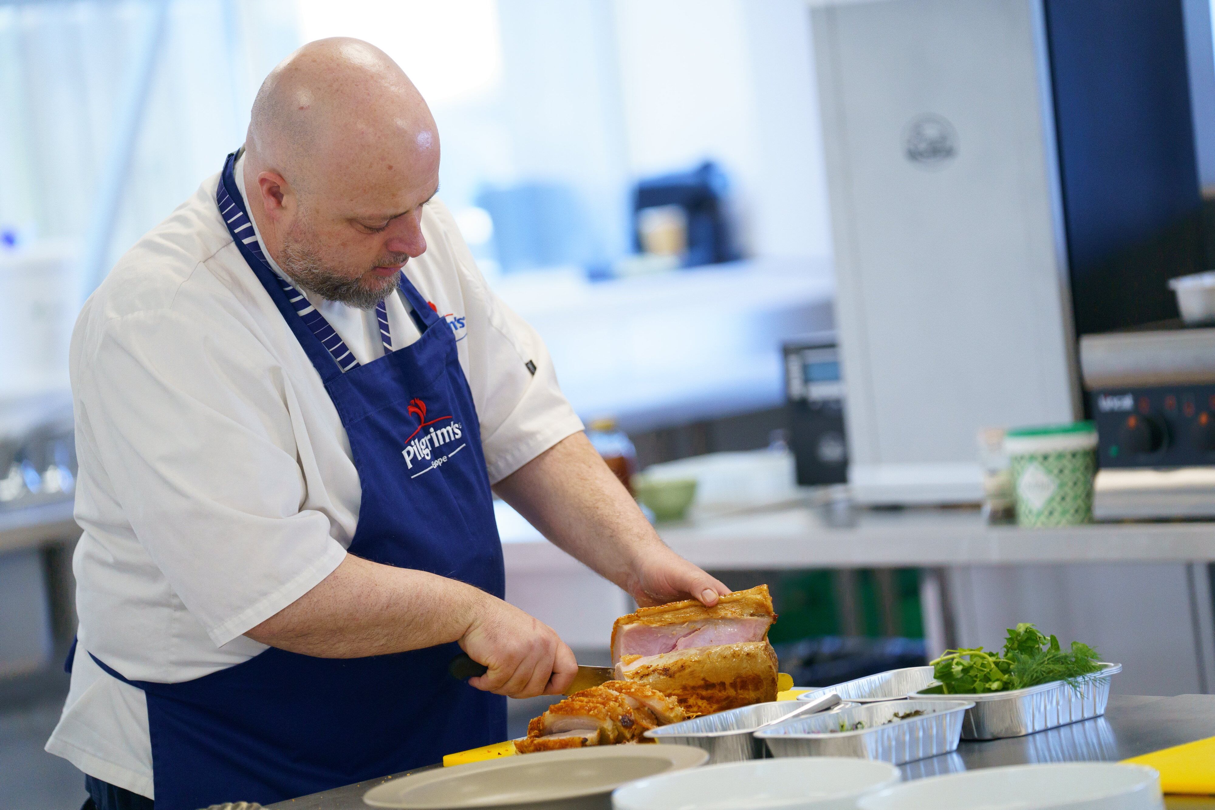 A man slicing pork.