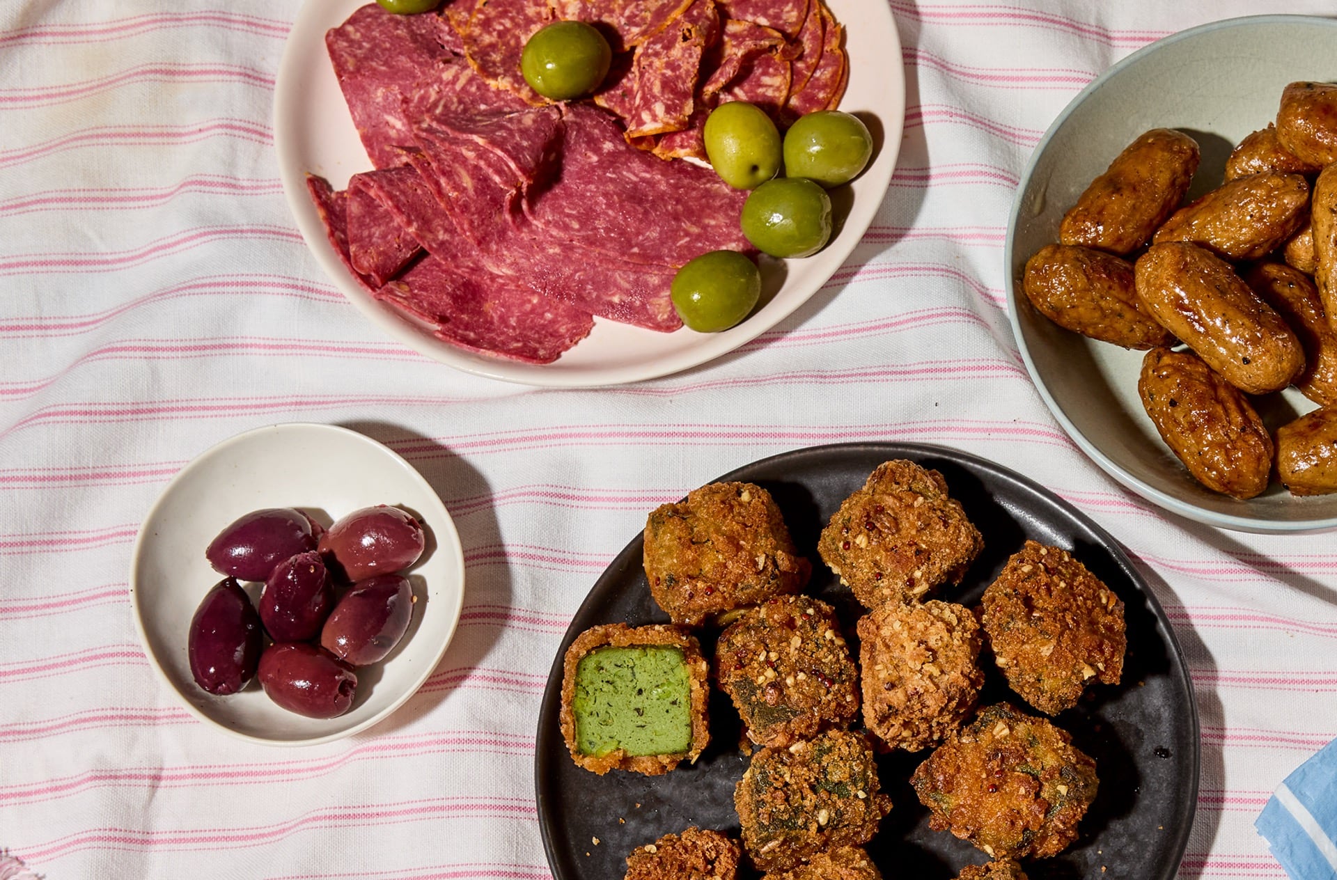 A platter featuring THIS isn't Beef Pastrami, THIS Is Super Veg Protein Bites, and THIS Isn't Pork Cocktail Sausages.