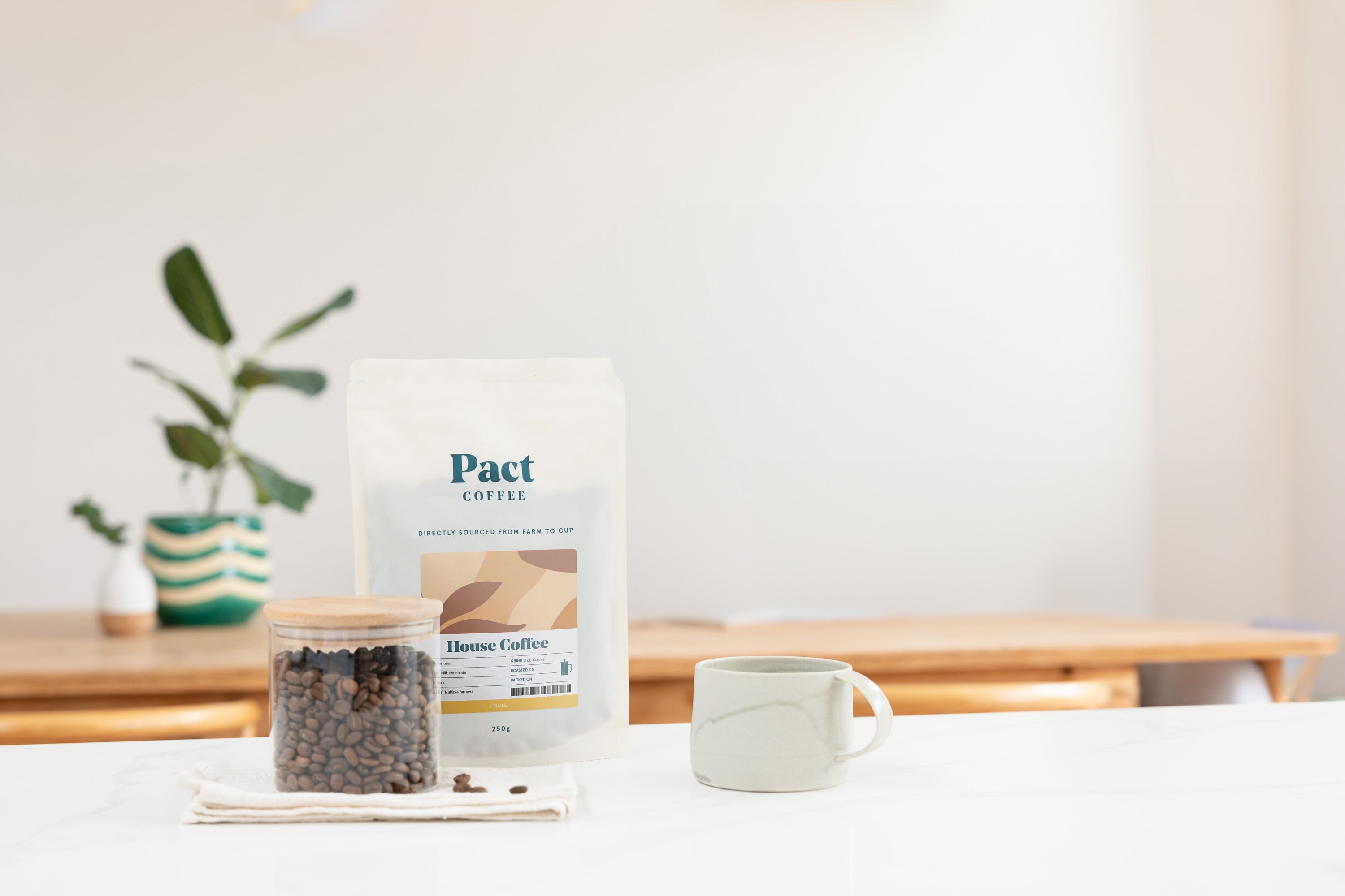 Pact coffee bag, granules and coffee cup.
