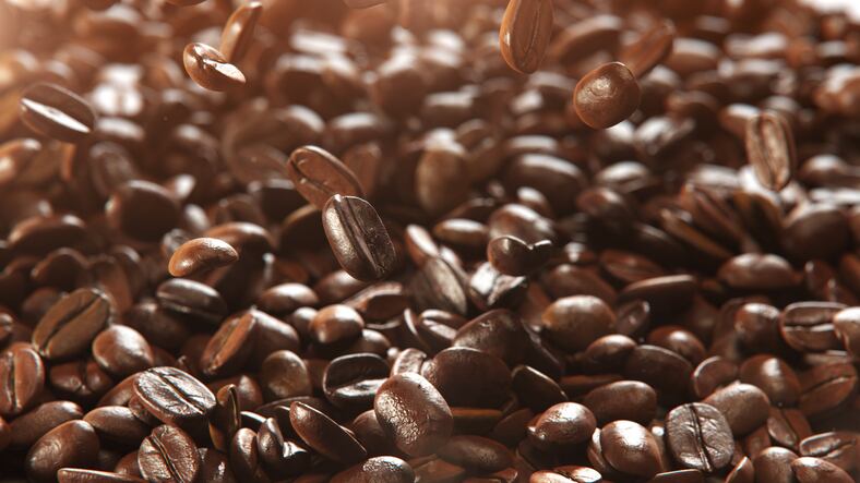 Close up Detail Shot of Coffee Beans Falling Down isolate on black background. 3D Render.