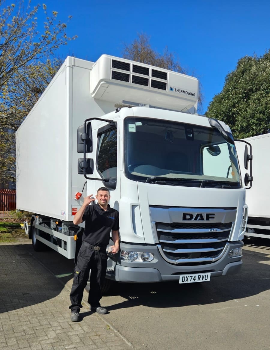 Man standing by HGV.