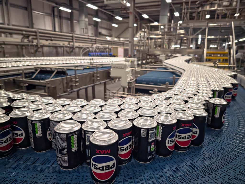 Cans of Pepsi on a production line.
