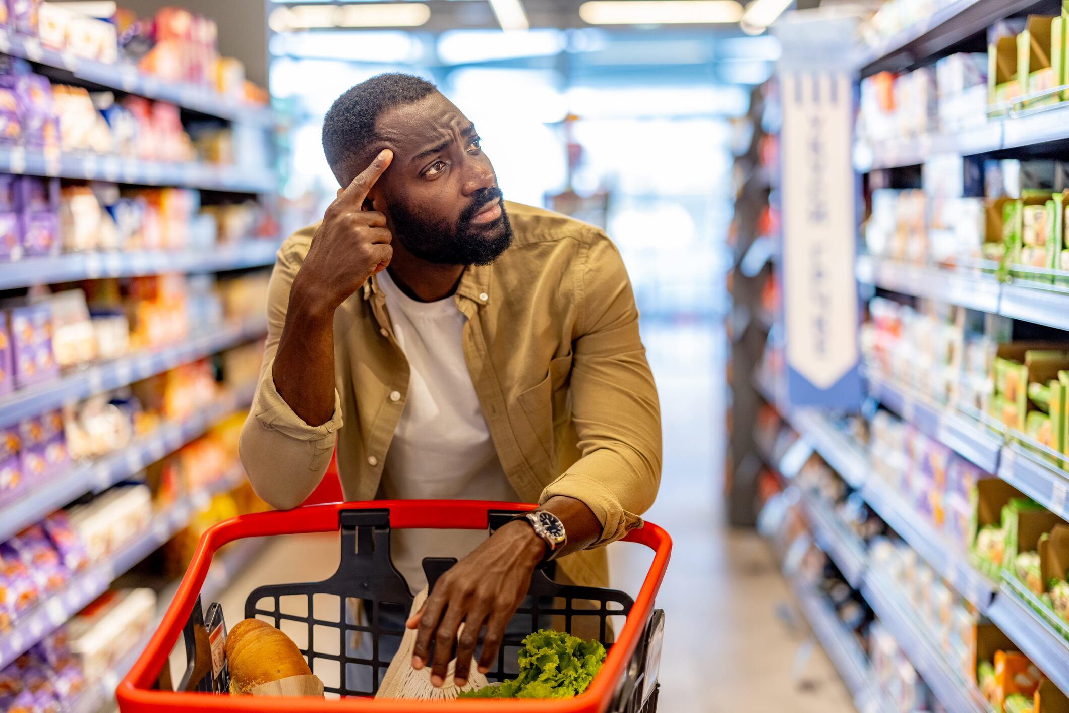 Man Shopping in Supermarket Displaying Thoughtful and Contemplative Expression