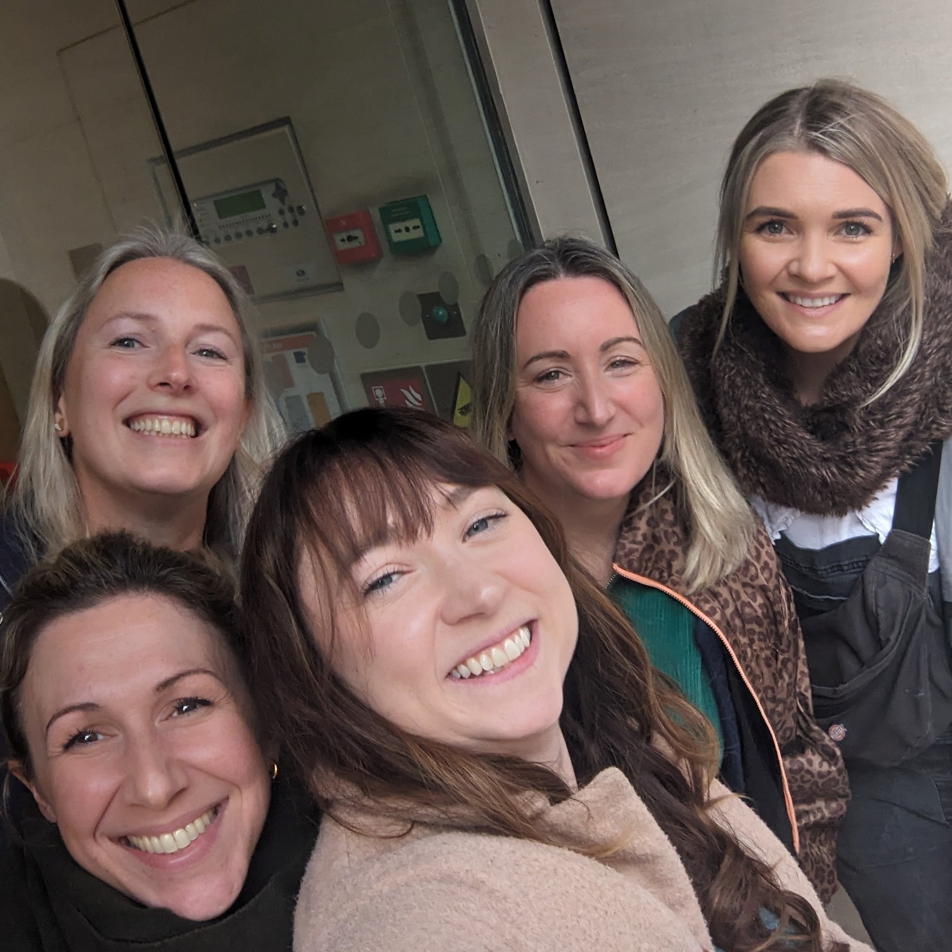 Five women taking a selfie.