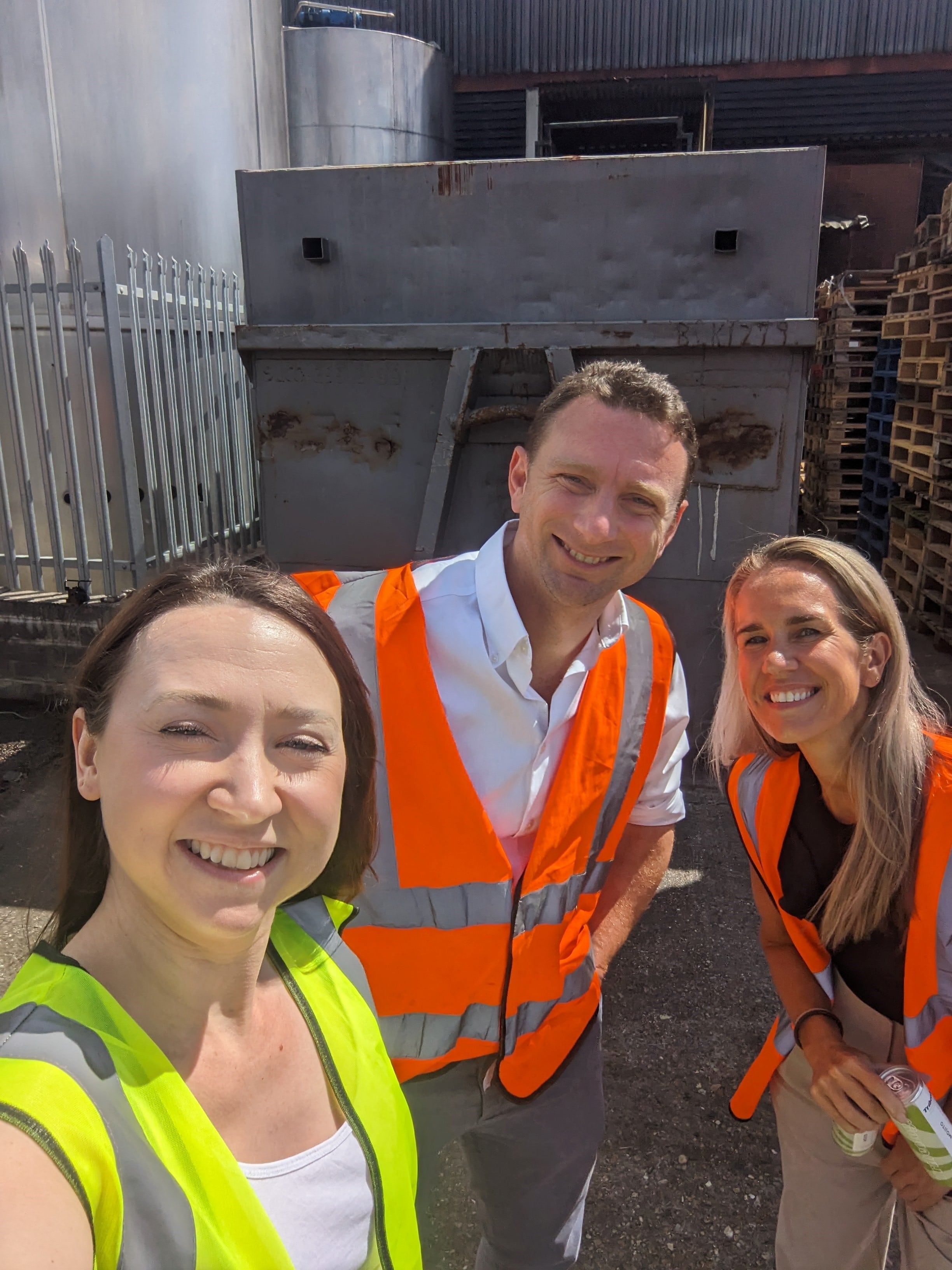 Bethan Grylls standing with Nick Kirby and Rachel Collins outside of Storefast Solutions facility.