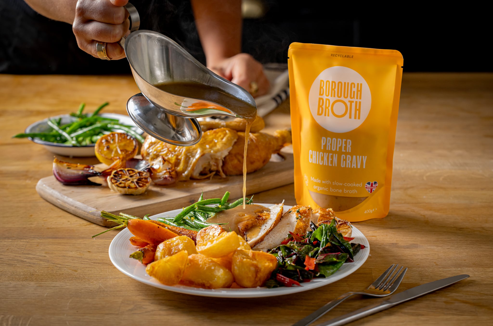 pack of gravy and roast dinner with gravy being poured over