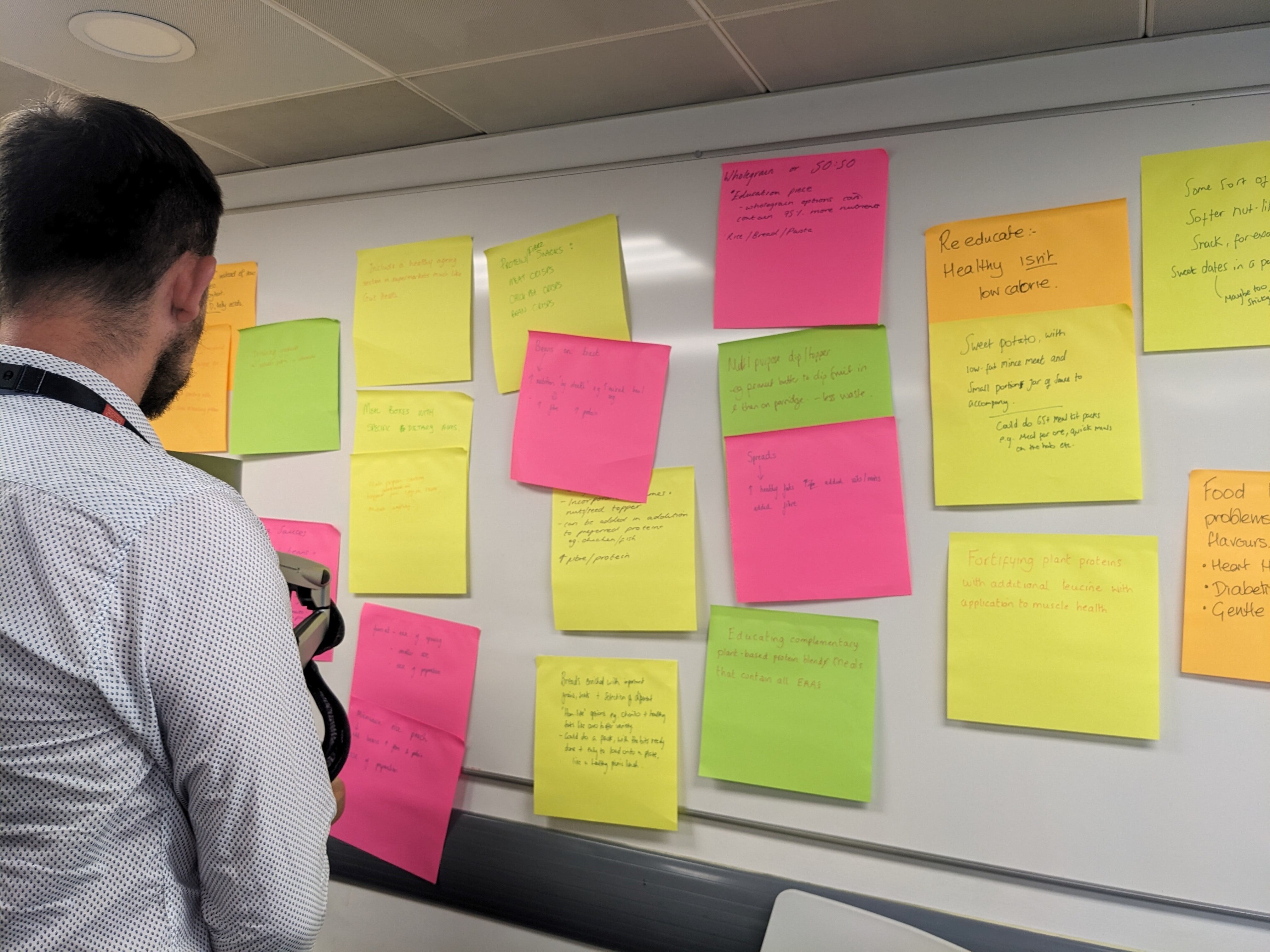Man looking at post-it notes