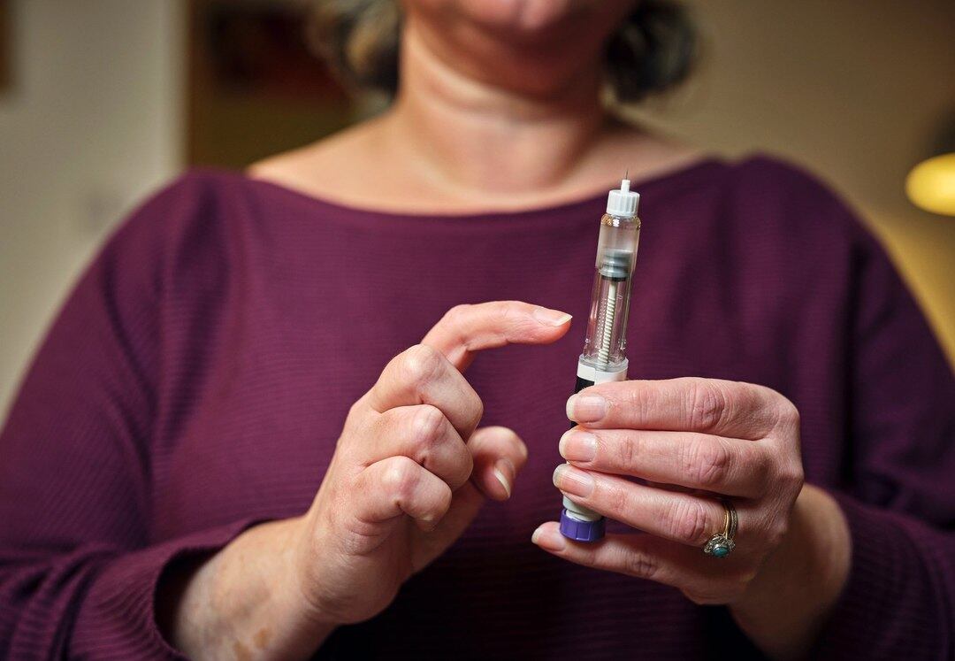 A woman with a GLP-1 injection