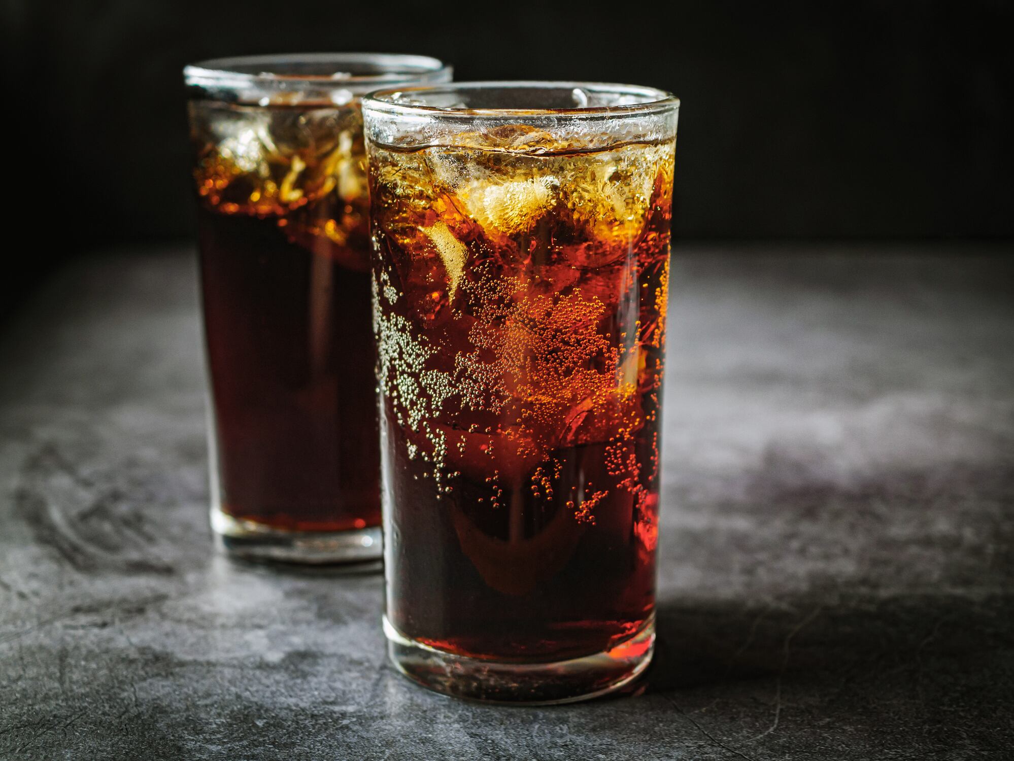 Two glasses full of cola