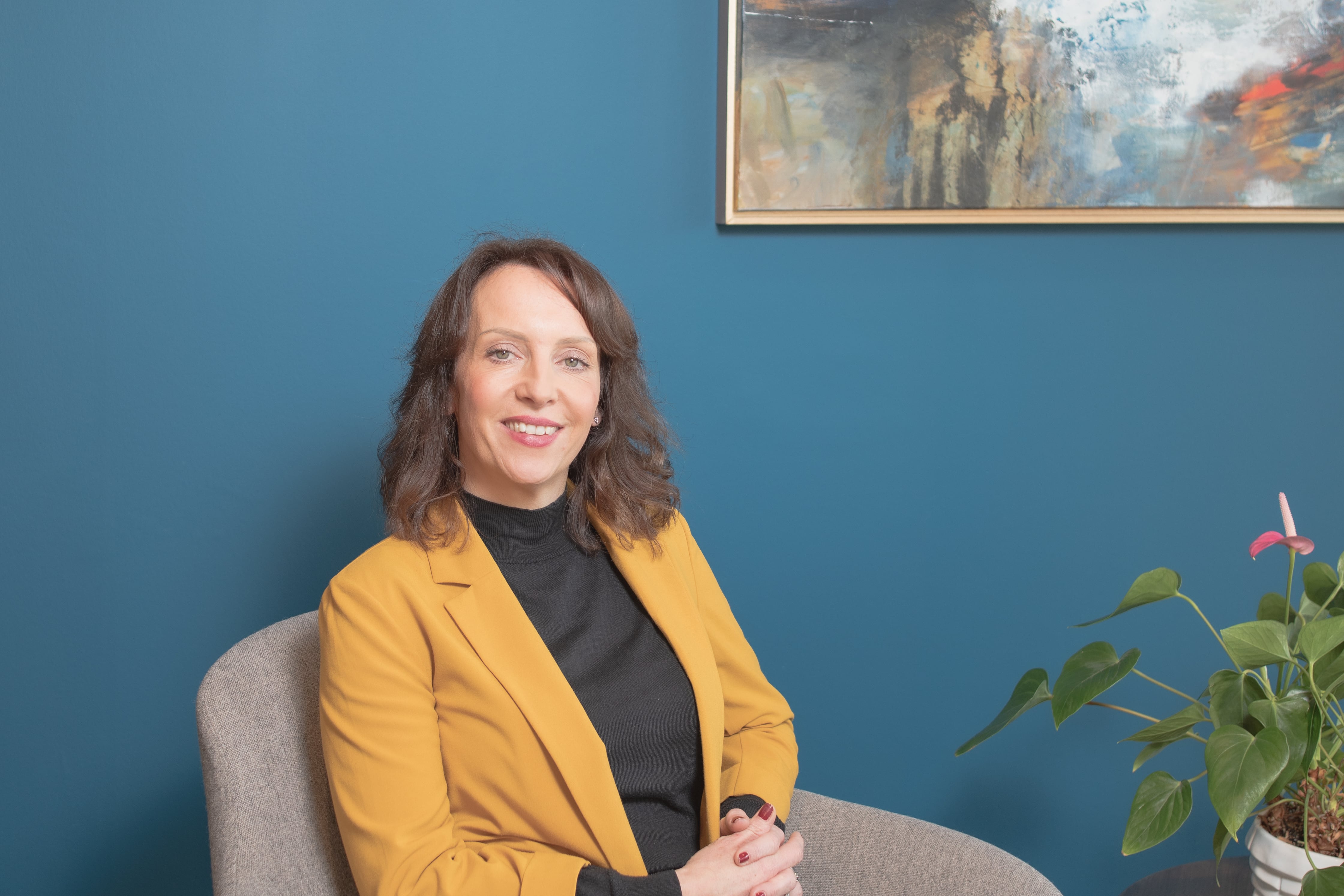 Julie Gowland sitting on a chair.