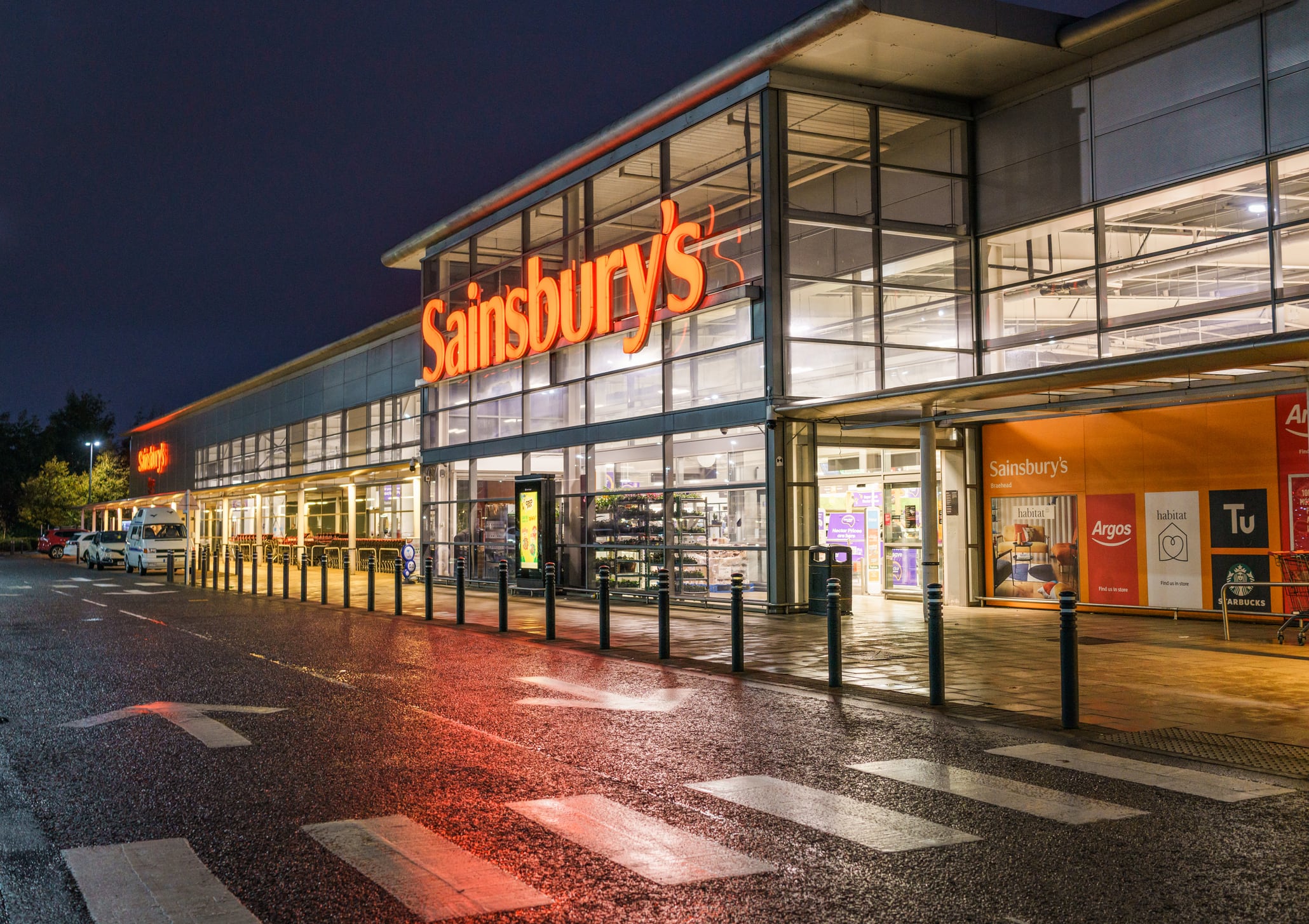 A Sainsbury's supermarket facade at night