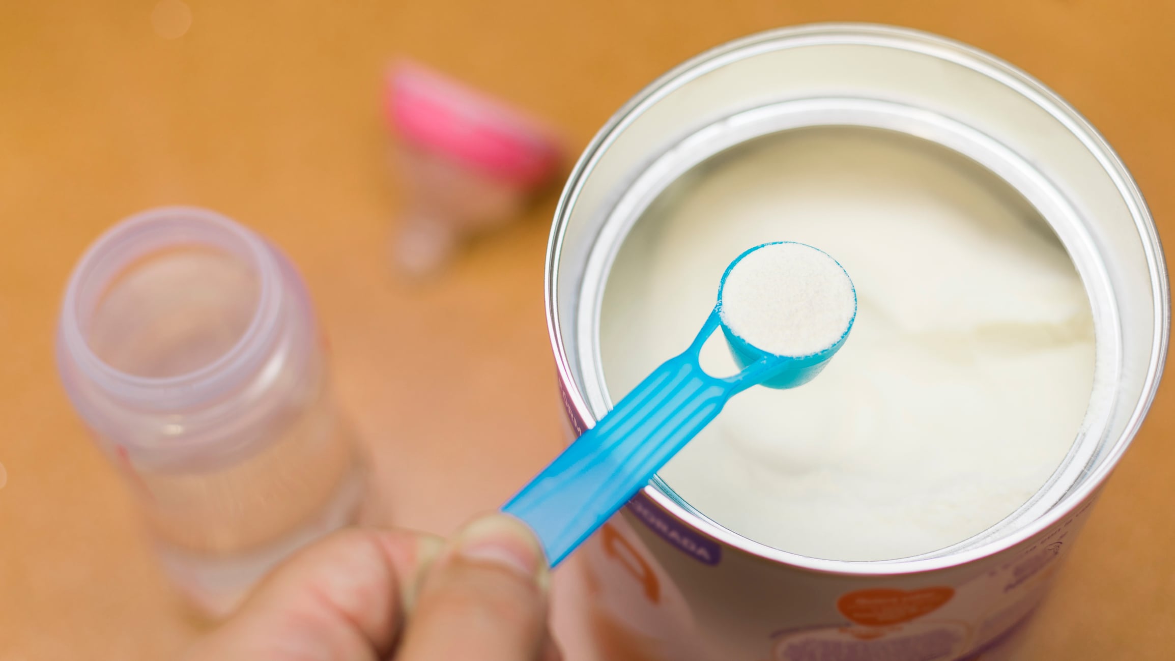 Baby formula opened and being scooped