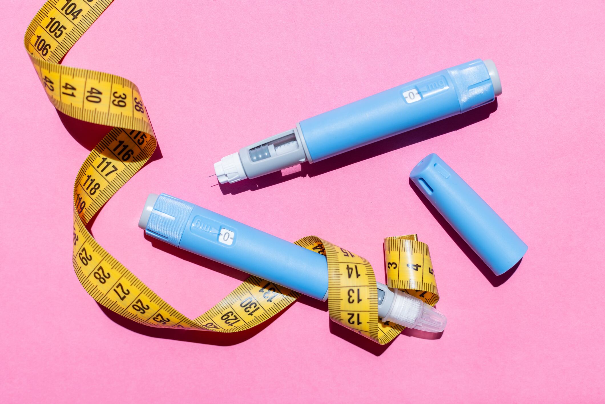Blue ozempic pen and tape measure.