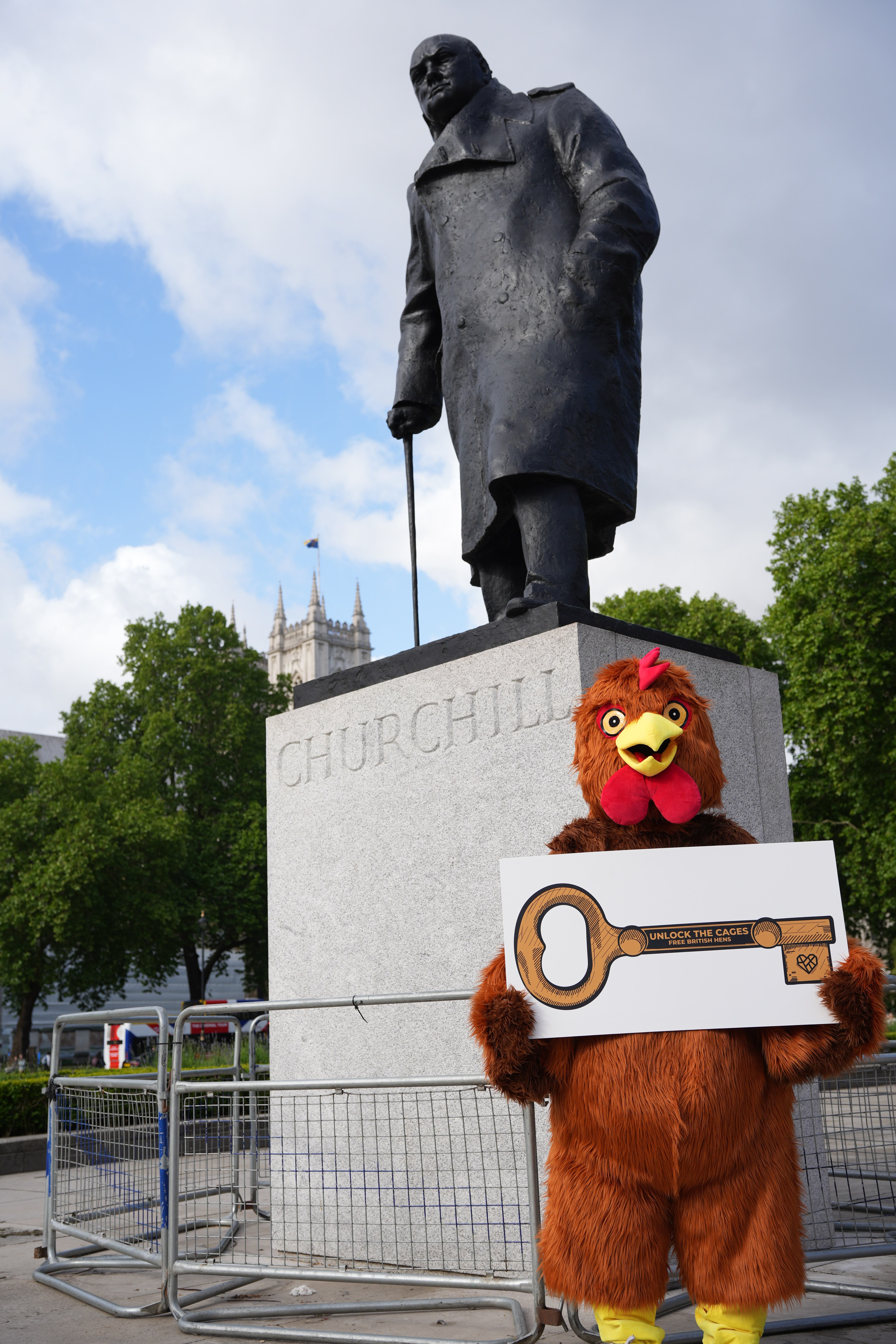 An activist posing with a statue of Winston Churchill.