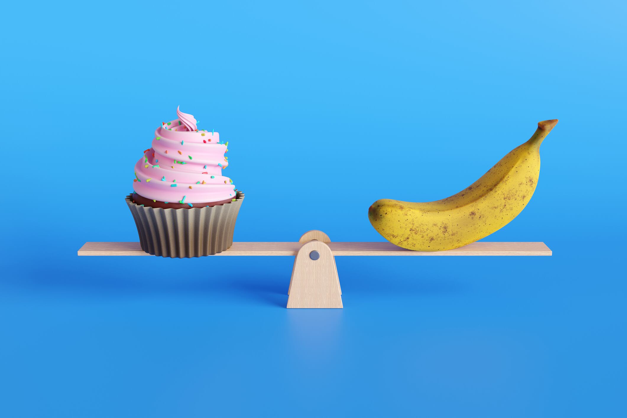 A banana and a cupcake on a scale.