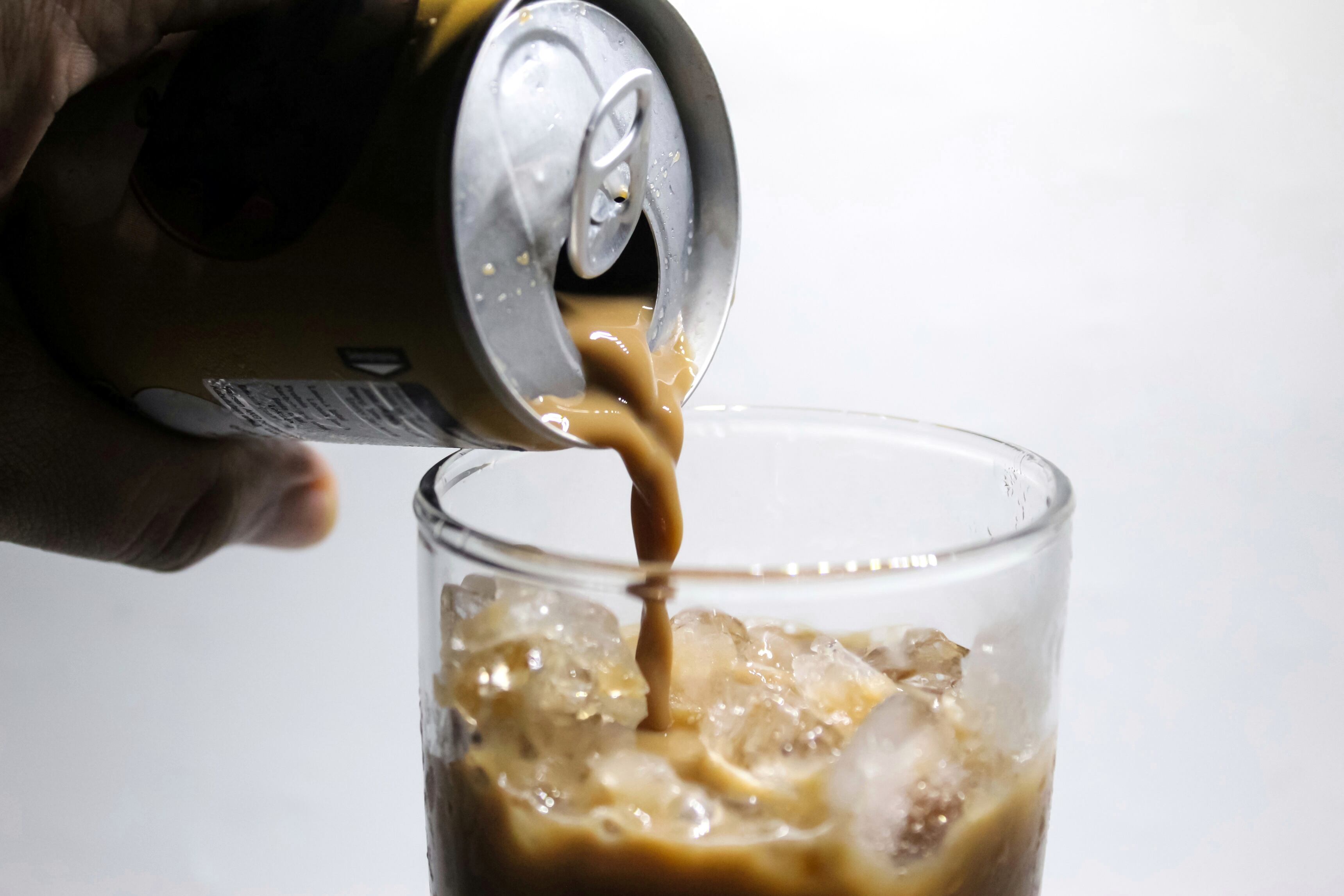 Cold brew coffee being poured into a glass.