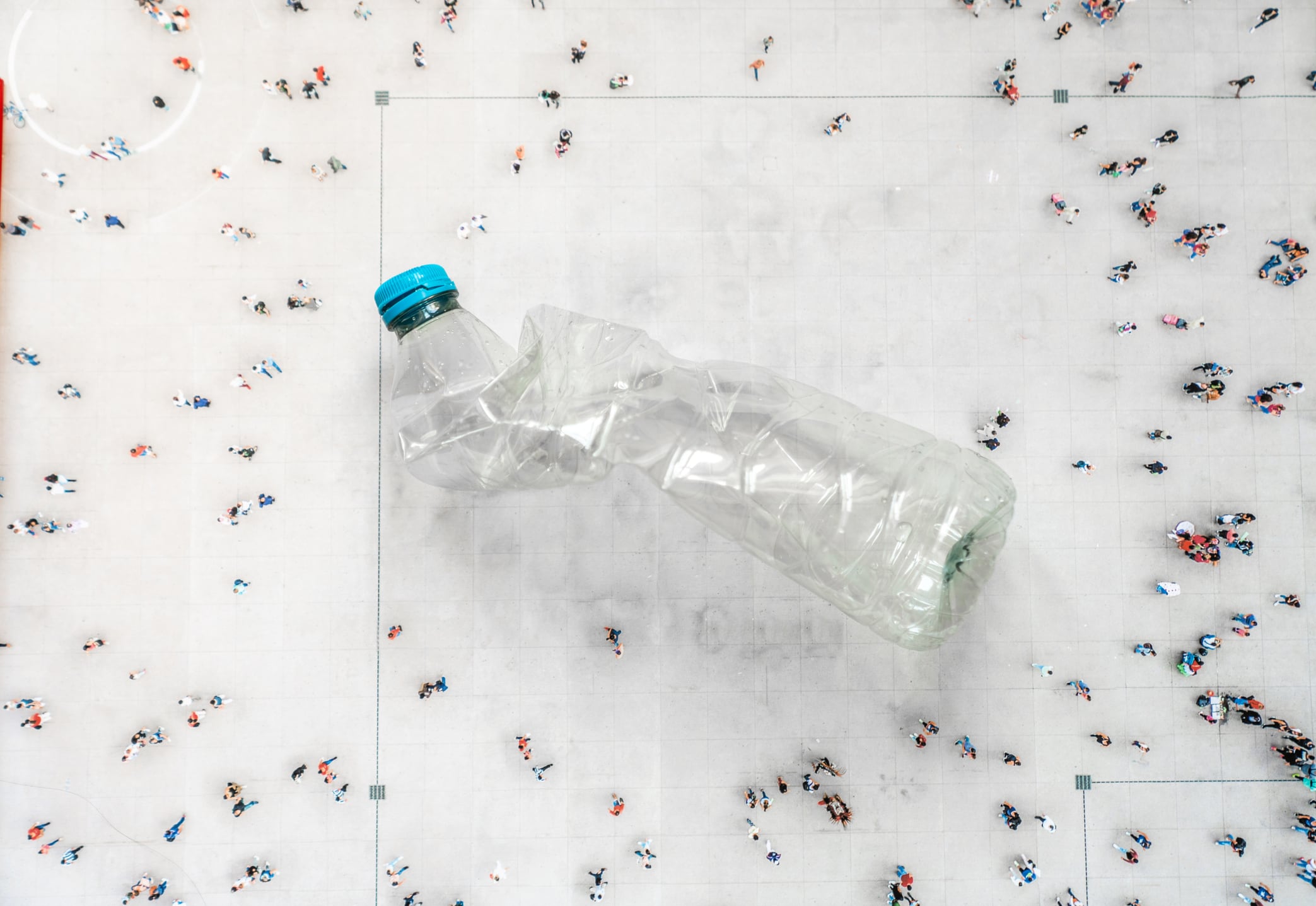 High angle view of people on street around a plastic bottle