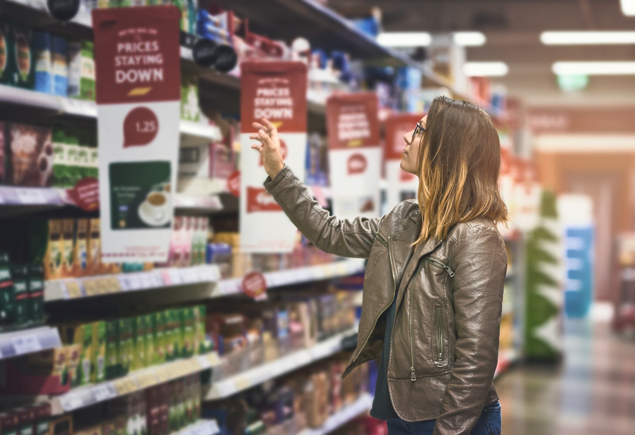Shot of a young woman shopping at a grocery store.