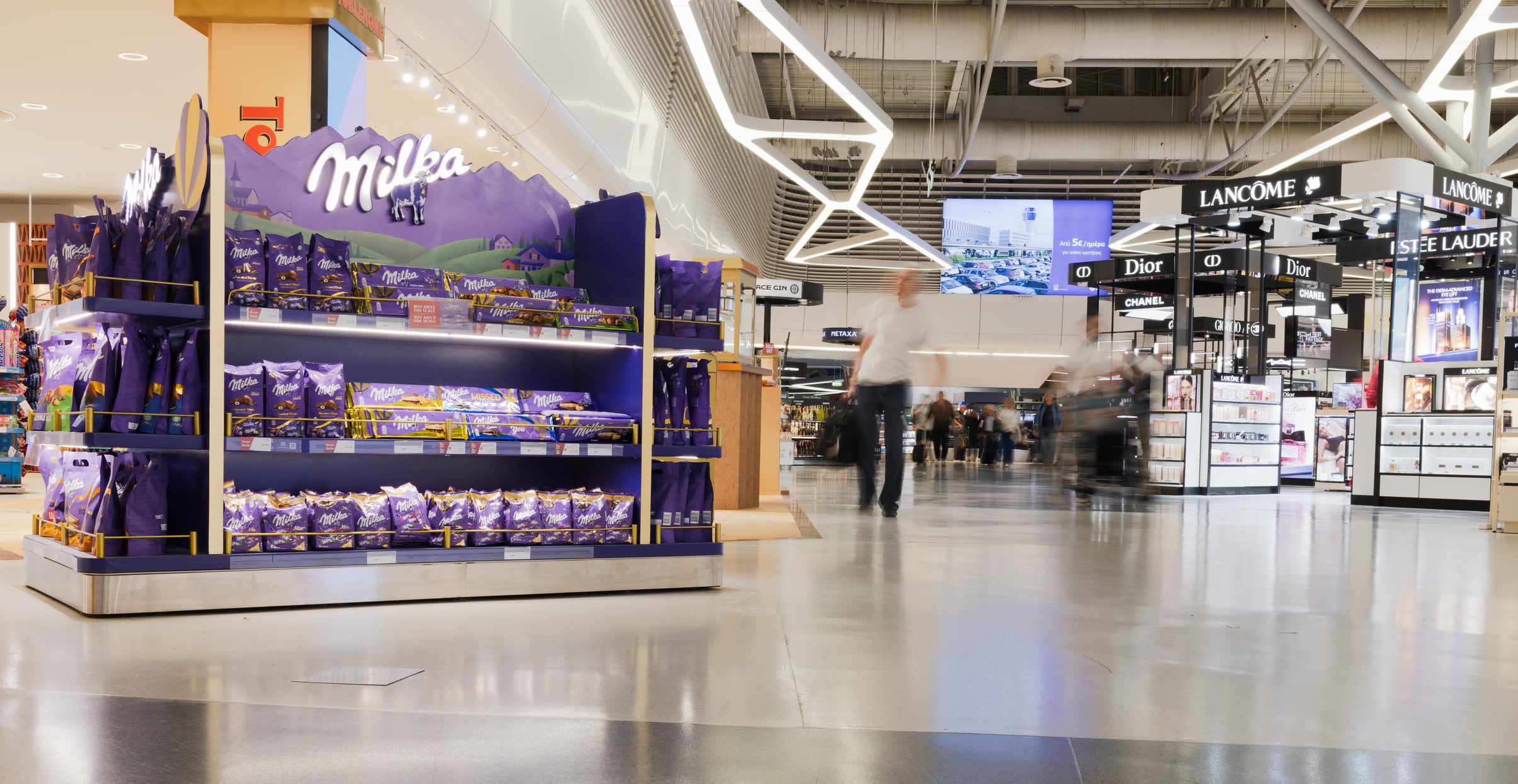 Duty-Free Shopping Area with Chocolate Displays and Cosmetics in a Modern Airport Terminal. Athens, Greece. 04 October 2025