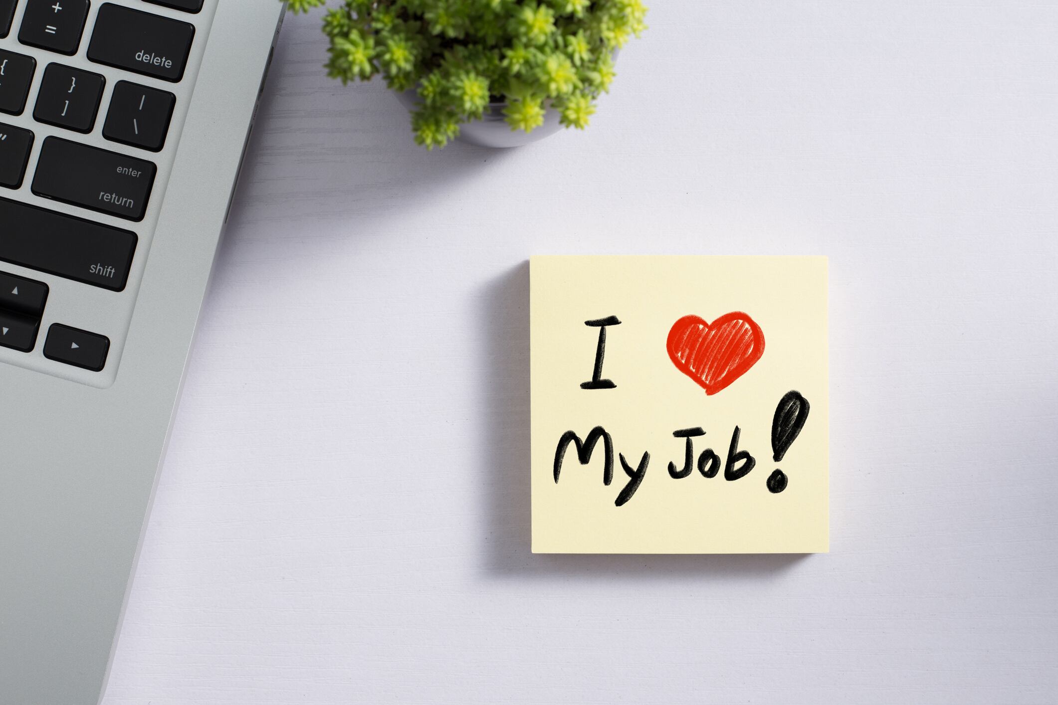 I Love My Job concept on office desk table with laptop and supplies. Top view with copy space.