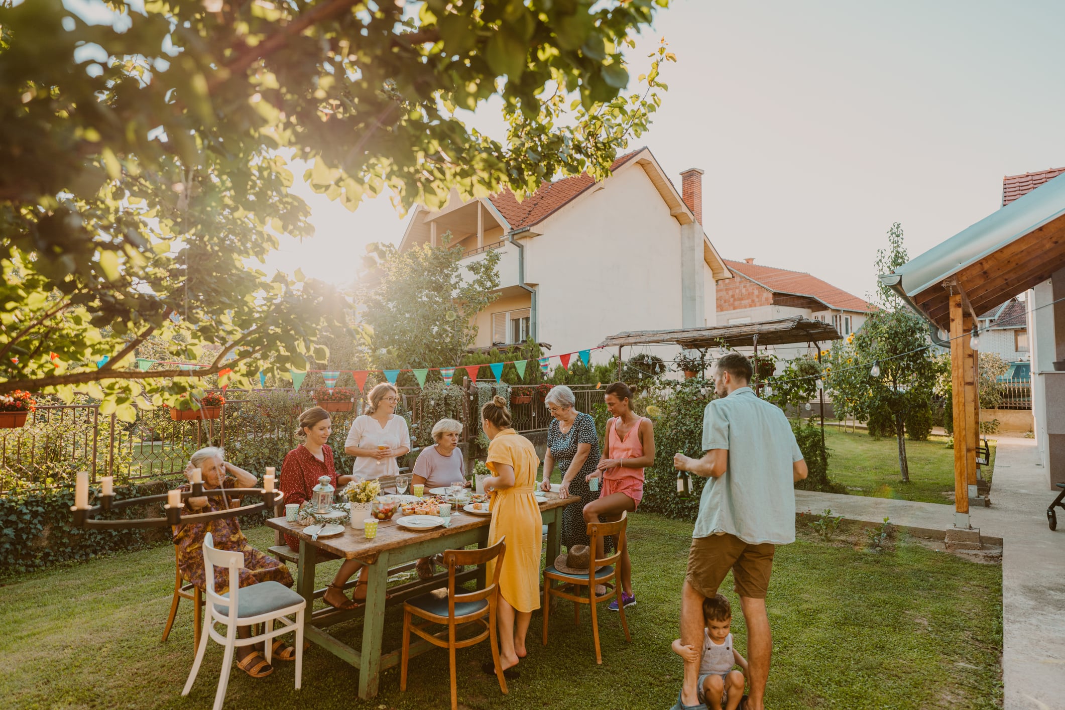 Photo of multi generation family, having party in the backyard. I