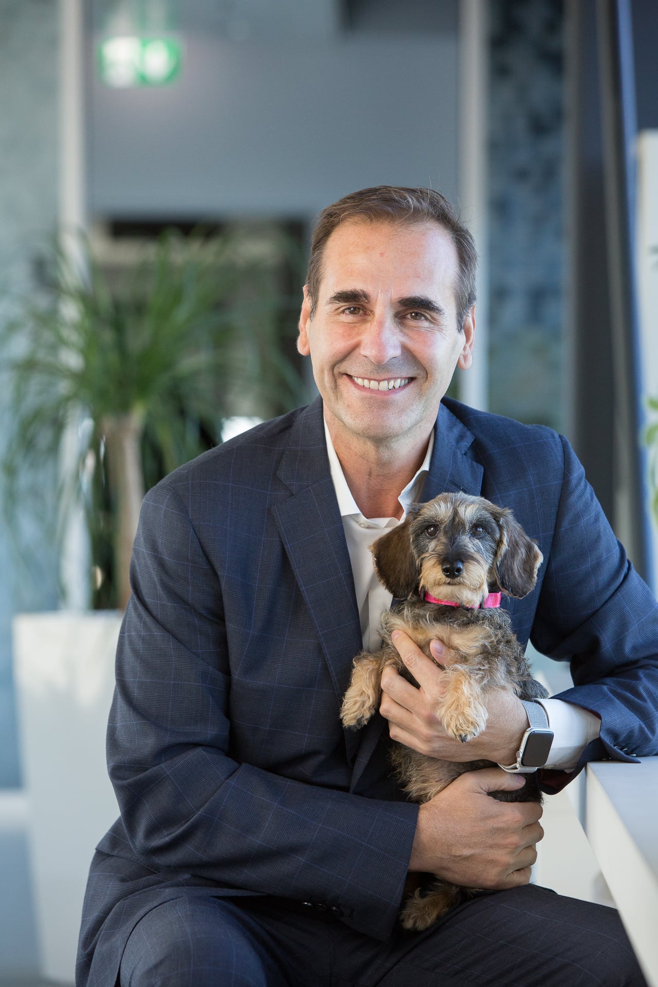 Rafael Lopez, Purina Europe, CEO holding a dog.