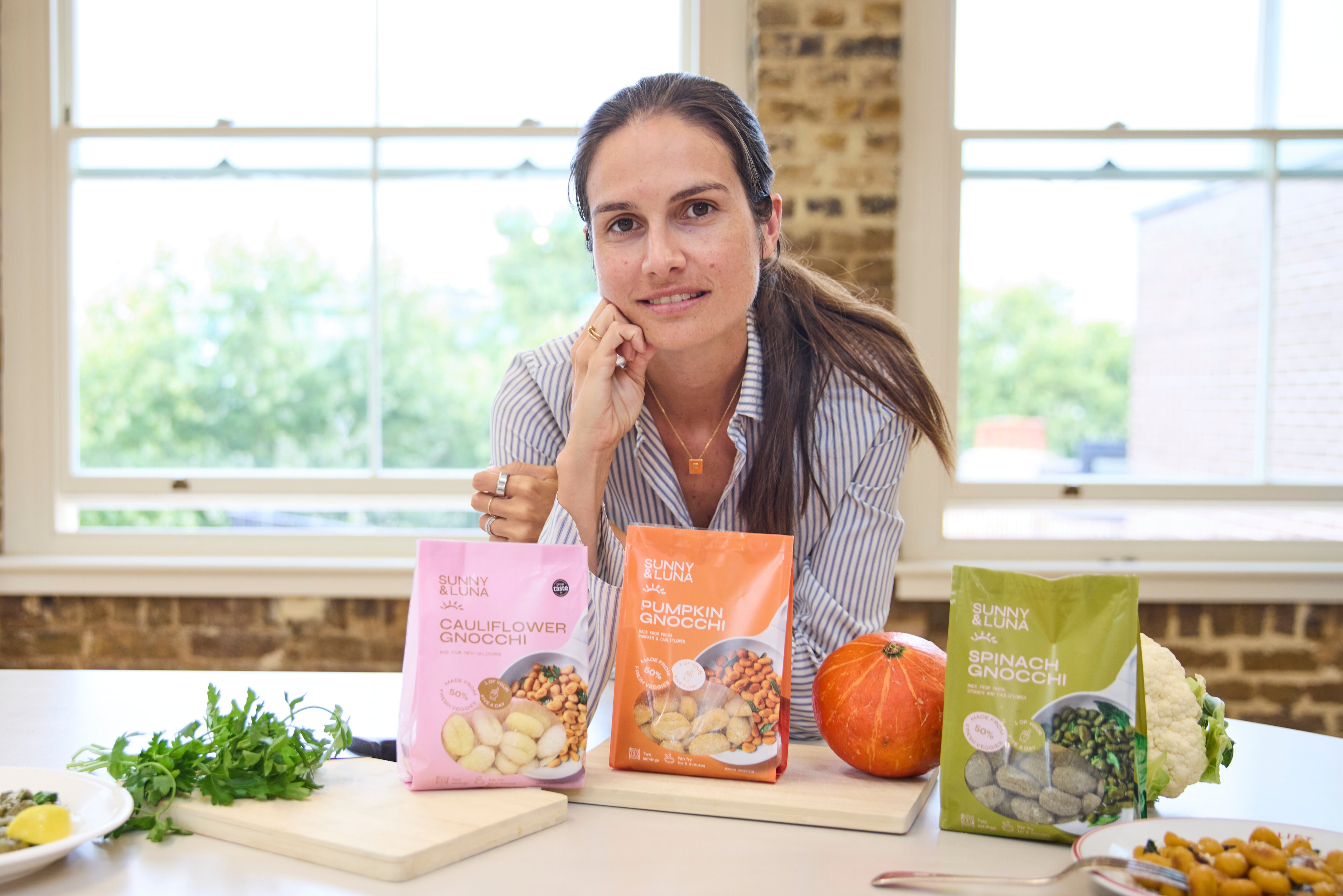 Giulia Berretti surrounded by pasta products.