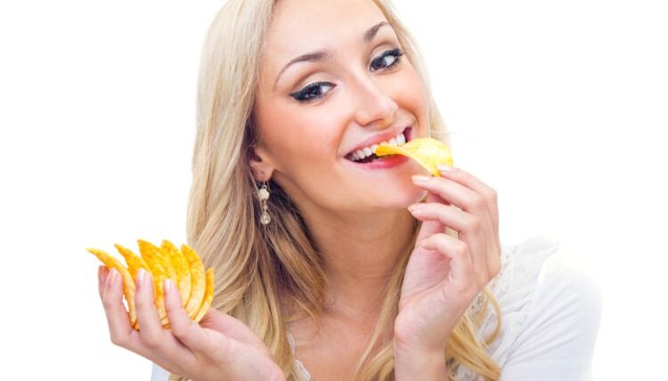 Woman eating Pringle-type chips