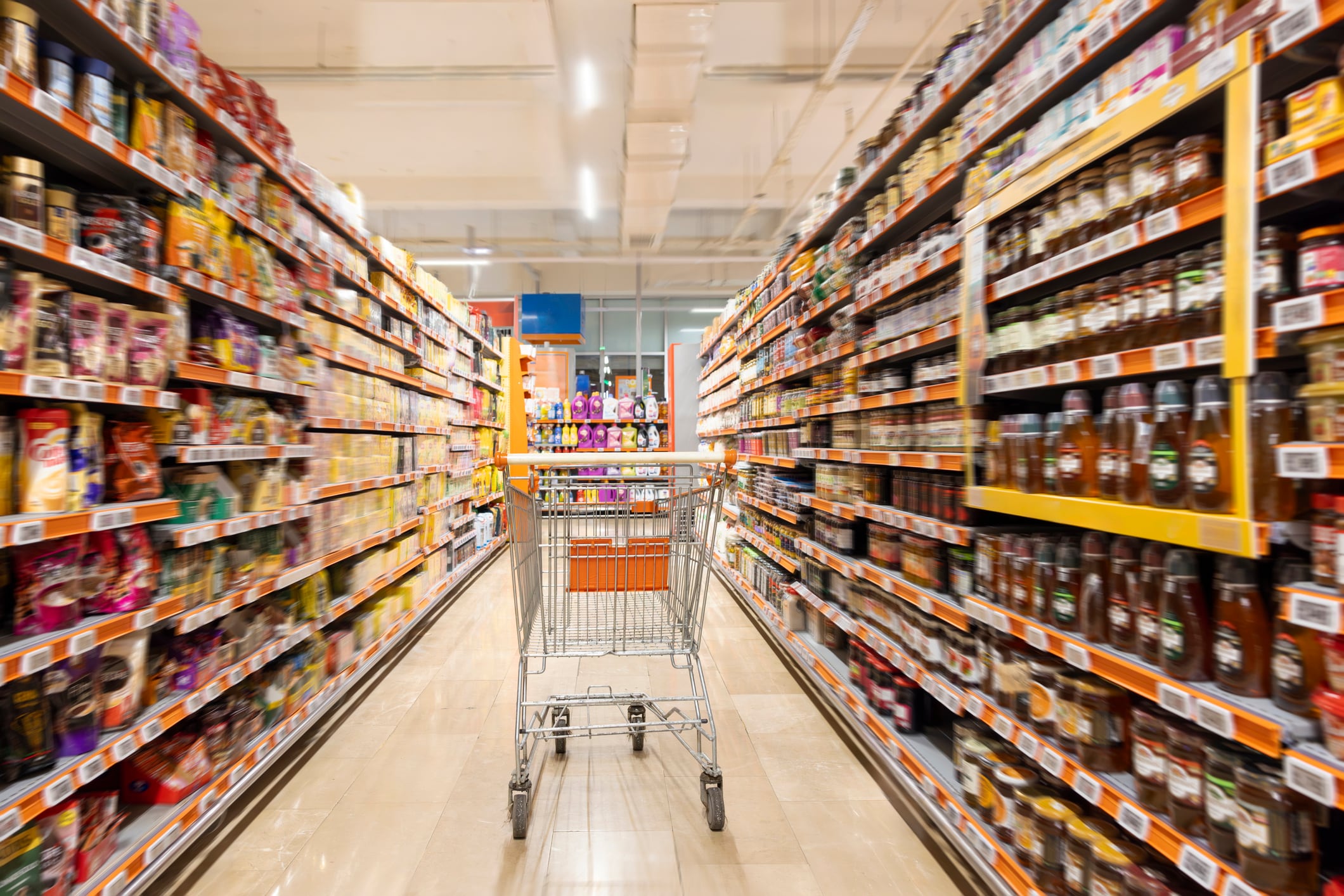 Empty cart in supermarket aisle
