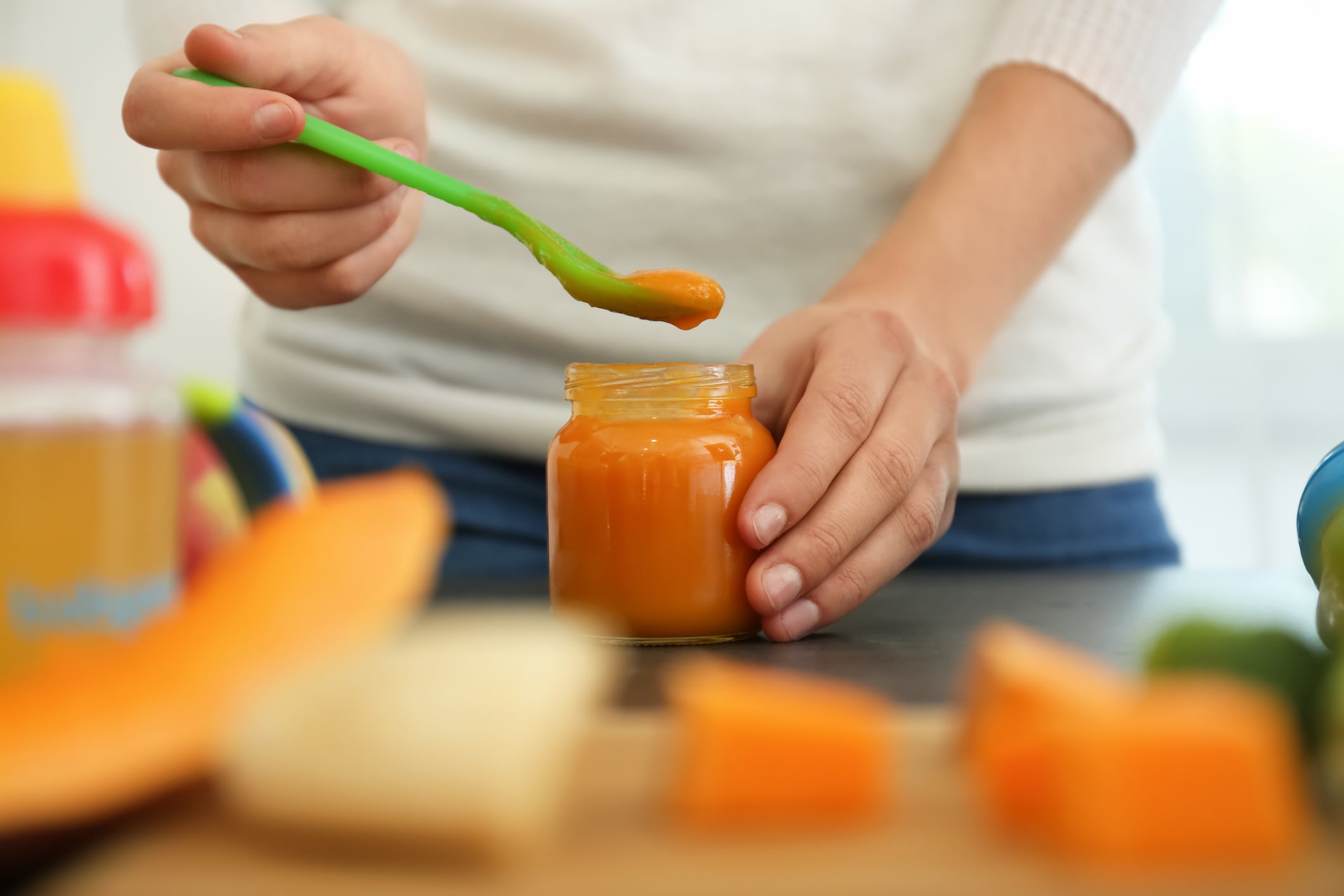 A woman preparing baby food jars