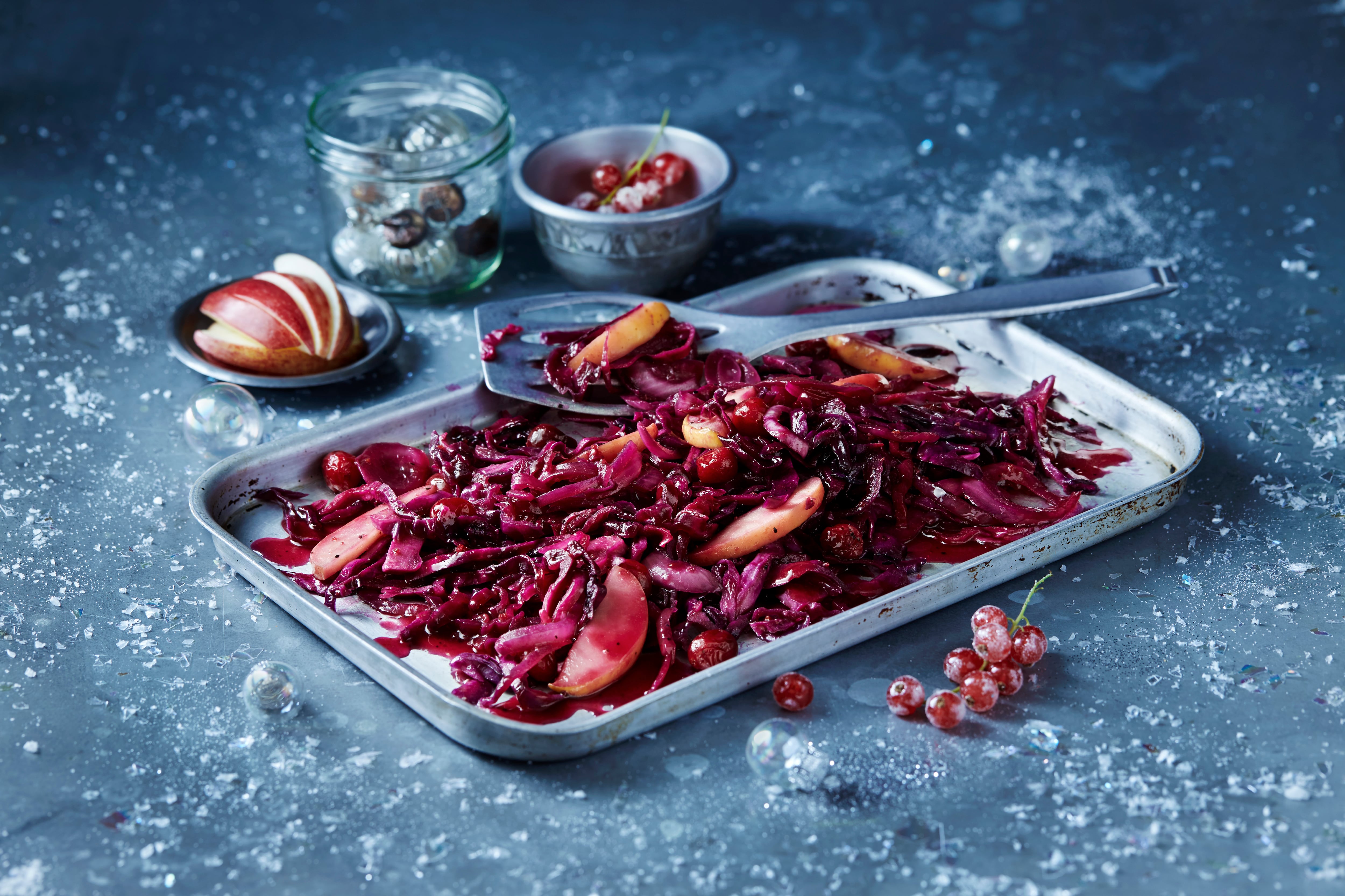 Roasted red cabbage and sliced apple in baking tin, seasonal Christmas food