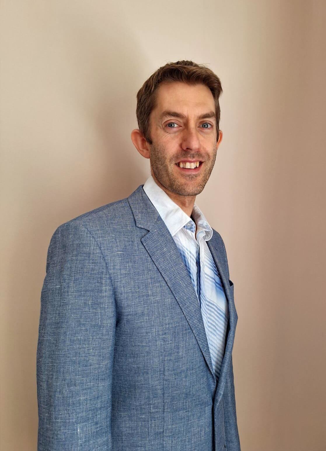 Andy Ditton, finance director at Golden Acre Foods, in a suit.