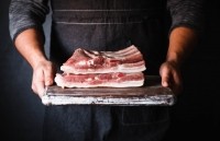 Bacon being held by a man