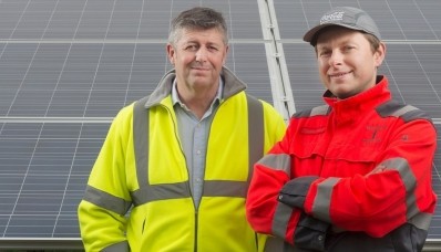 Stephen Butterfield (l) with Tomasz Parzyk, environmental manager at CCEP Wakefield, in front of the solar farm