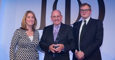 Winner: Lord Allen (centre) with IoD director Kate Brackenbury and awards host Miles Jupp