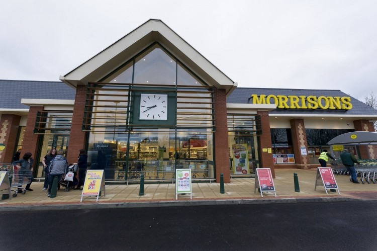 Morrisons has reported half-year profits down by more than 30%