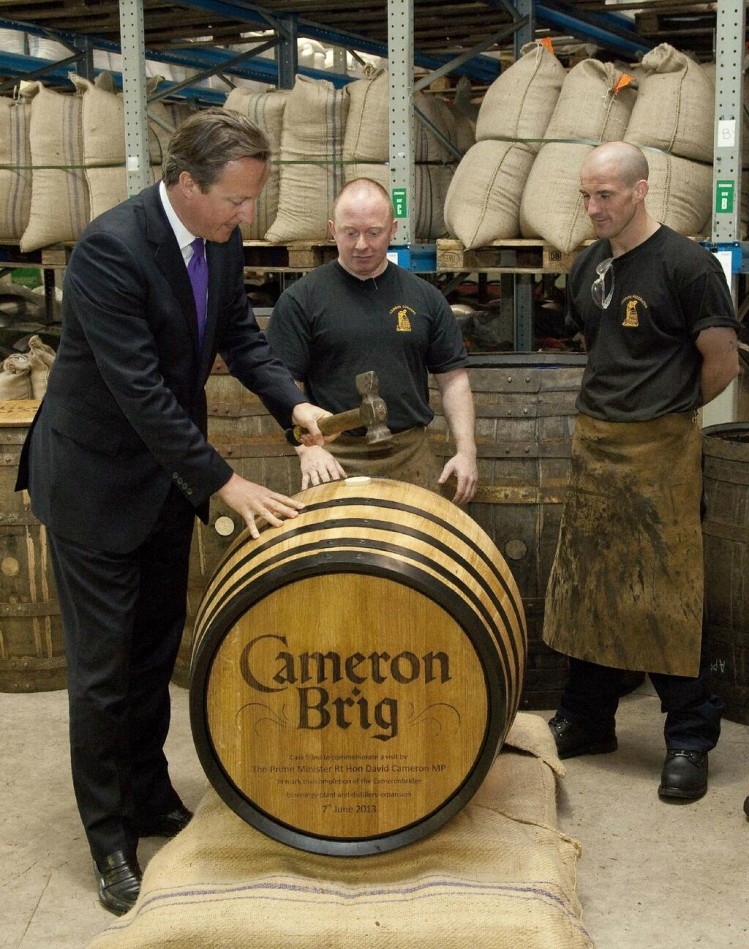 David Cameron hammered the bung into a cask of Cameron Brig whisky. Is this the first time he has been pictured over a barrel?