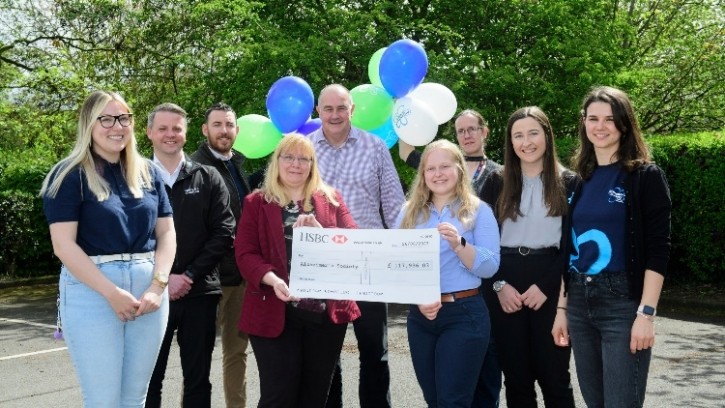 Moy Park employees pose with the cheque raised for Alzheimer’s Society