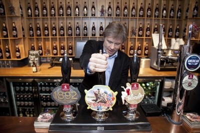 Iron Maiden vocalist Bruce Dickinson pulls a pint of Trooper