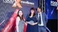 Kate Clawson poses with Food Manufacture editor Bethan Grylls and host Mark Watson